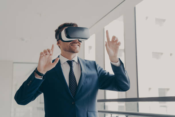 istock Excited office worker in vr headset or virtual reality goggles gesturing with hands 1488143090