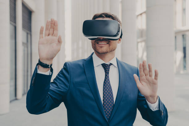istock Businessman in suit trying out and experiencing virtual reality using mobile VR headset outdoors 1488143164