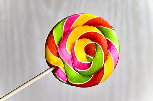 Multicolored lollipop on a light background.