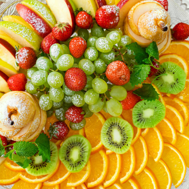 istock fruit plate with grapes, oranges, kiwis, apples and strawberries, top view 1488151414