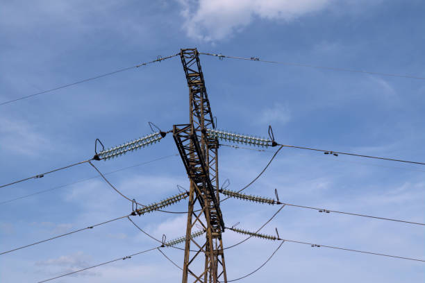 istock Electricity pylon against a blue sky , power transmission background. 1488162822