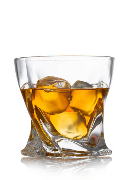 istock Luxury glass with whiskey and ice cubes on white background. 1488163334