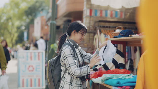Asian business traveller shopping at a traditional souvenir market in japan.