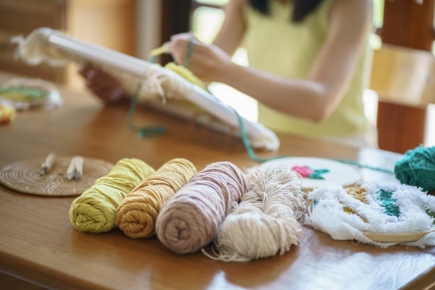 istock Punch needle. Asian Woman making handmade Hobby knitting in studio workshop. designer workplace Handmade craft project DIY embroidery concept. 1488167456