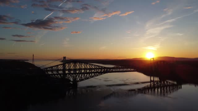 Panning upward on Quebec city bridge during sunset