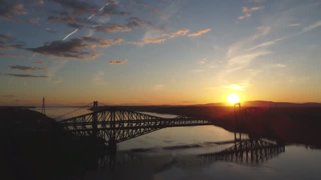 Panning downward on Quebec city bridge during sunset