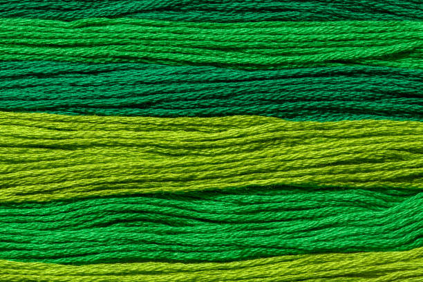 istock Background wallpaper for text. Texture of green threads of different shades arranged in parallel. Different shades of green 1488169821