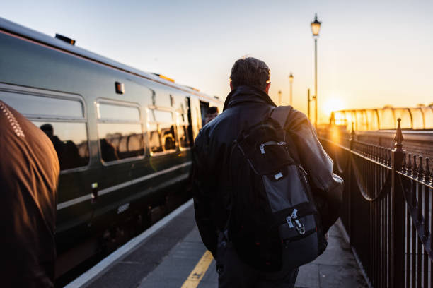 Mature Man Walking To And Entering A Train