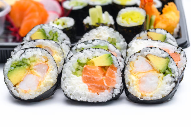 istock Rolled sushi with salmon, crab, avocado and rice on a white background 1488173720