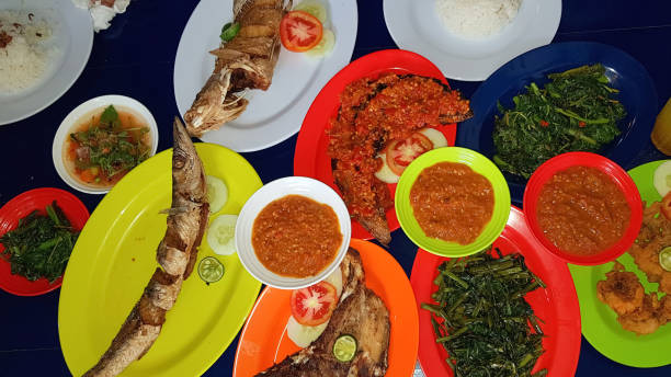 istock Seafood dish served on the table and plate from above with different kind of dish from fried fish barracuda, snapper, tuna jaws, and also mix of tropical vegetables 1488175030