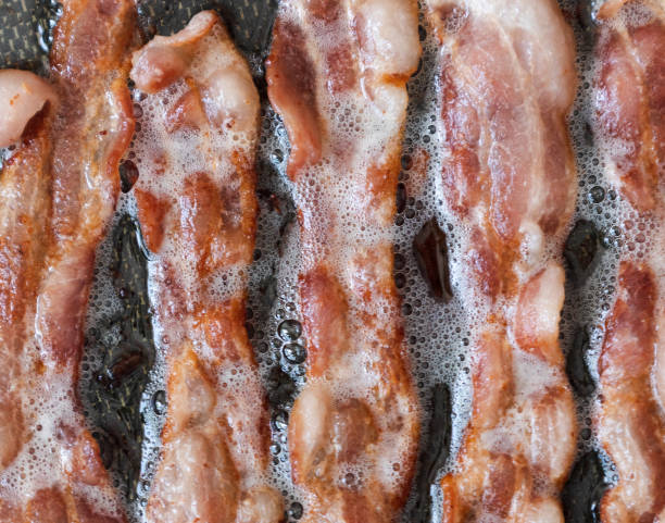 vista de primer plano de tocino chisporroteando en la sartén - grasa saturada fotografías e imágenes de stock