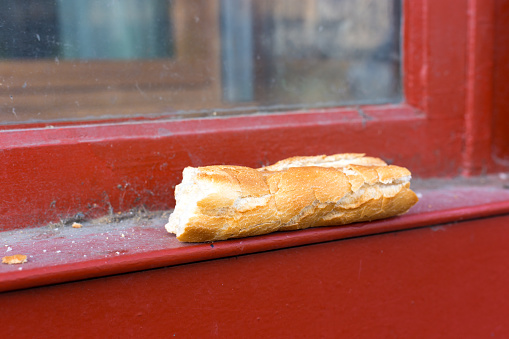 Lyon, France: Piece Crusty Baguette Left on Red Windowsill