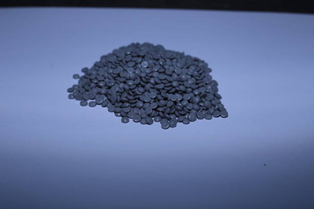 istock Grey of plastic polymer granules on white background. 1488181974