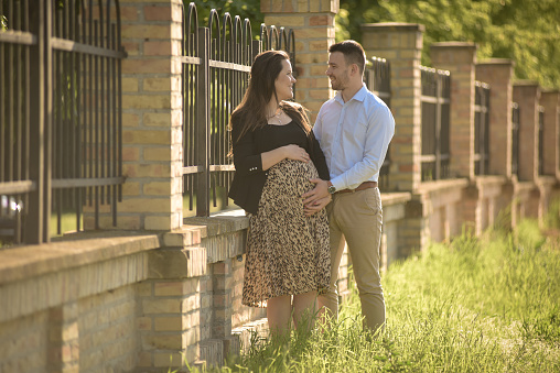 A young expecting couple enjoying together in the nature