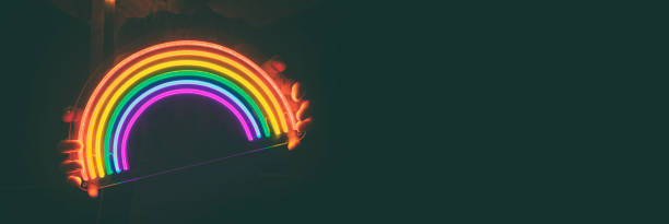 istock Guy holds neon led rainbow in hands in the night 1488189813