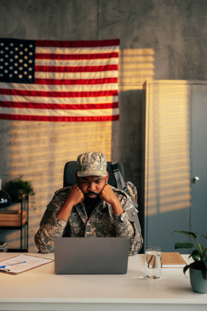 istock Pensive soldier working in office. 1488191929