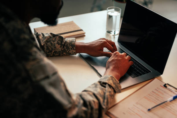 istock Military officer typing on laptop in office. 1488191936