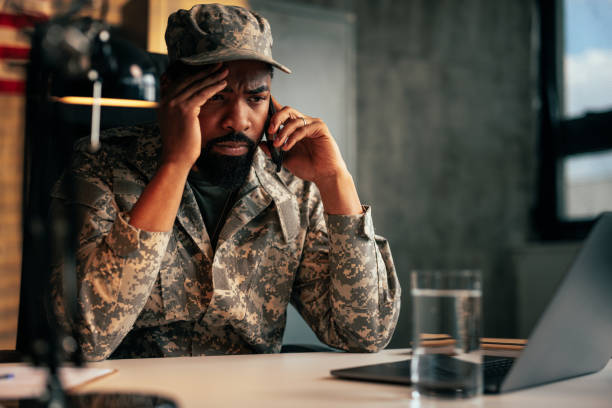istock Serious soldier talking on mobile phone in office. 1488191937