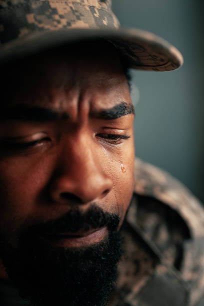 istock Sad soldier crying in office. 1488191947