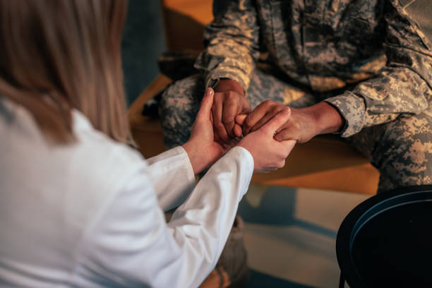 istock Soldier and therapist holding hands. 1488191978