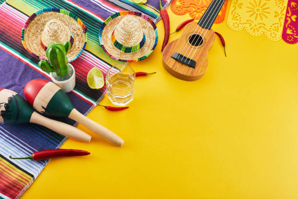 istock Cinco de Mayo holiday background. Maracas, cactus and hat on yellow background. 1488192054