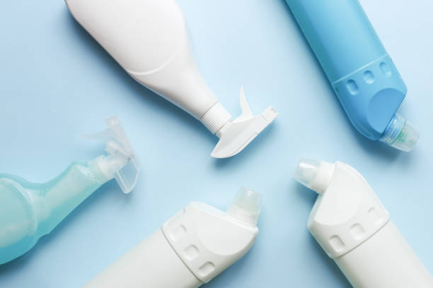 istock Cleaning bottle mockup. Flat lay cleaning products on blue background 1488193622