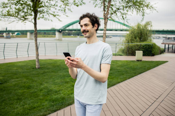 istock Shot of a young man using his smartphone 1488194041