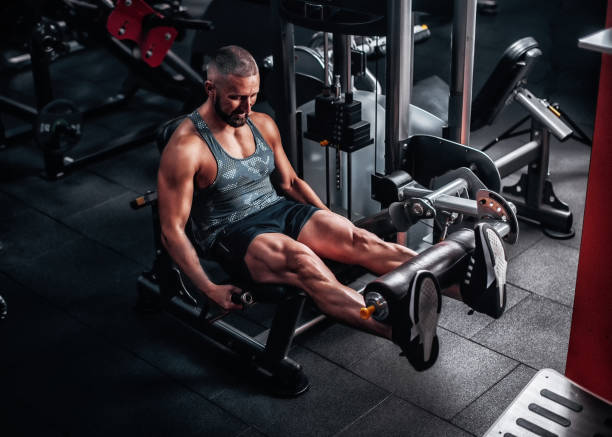 istock Man in gym training at weights machine to define his leg muscles 1488194202