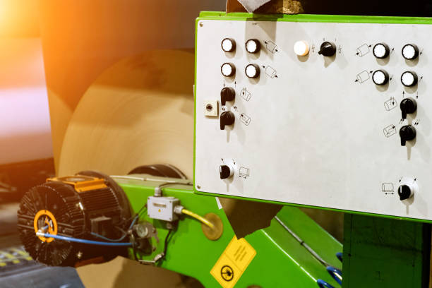 istock Push-button control panel for the machine for the production of cardboard from paper at the factory for the production of cardboard containers. 1488196838