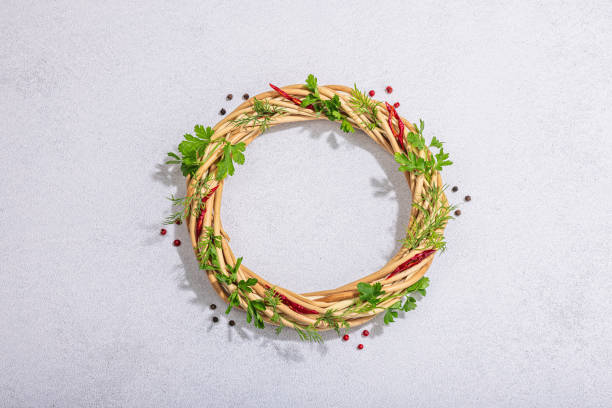 istock Culinary wreath with fresh greens, chili and peppercorn. Round frame, place for text, flat lay 1488201462
