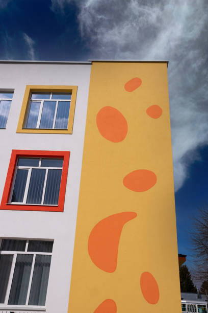 istock Orange wall of a multi-storey building against a blue sky. 1488201563