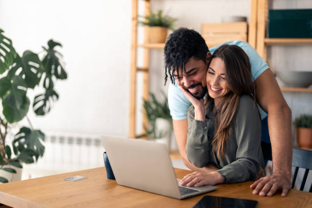 istock Attractive woman spending time on the internet with her husband 1488201969