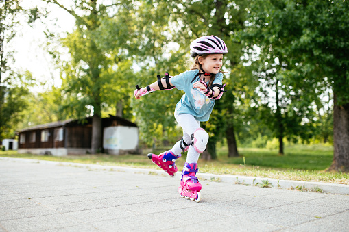 Girl in protective sportswear in skate park