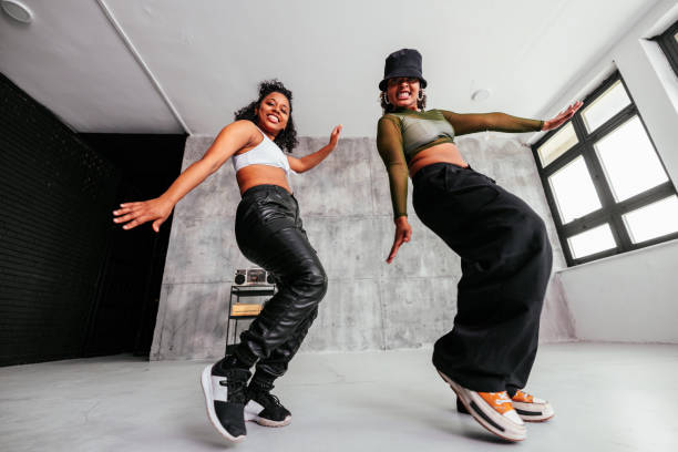 istock Stylish girls dancing in studio. 1488212476