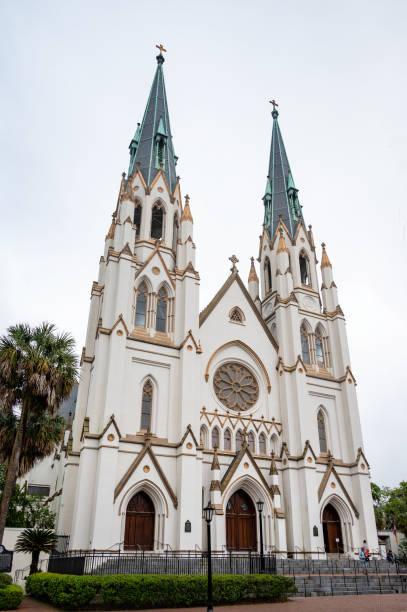 Savannah, Georgia - April 13, 2023: Exterior of the Cathedral Basilica of St. John the Baptist is a Roman Catholic cathedral and minor basilica in Lafayette Square at 222 East Harris Street, Savannah, Georgia, in the United States.