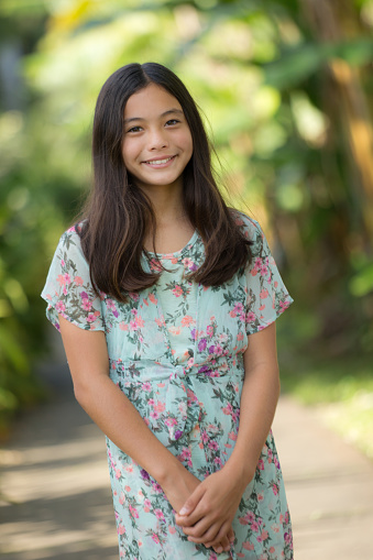 Studio shot of cheerful beautiful Asian woman in white t-shirt and stand smiling with braces on white background.