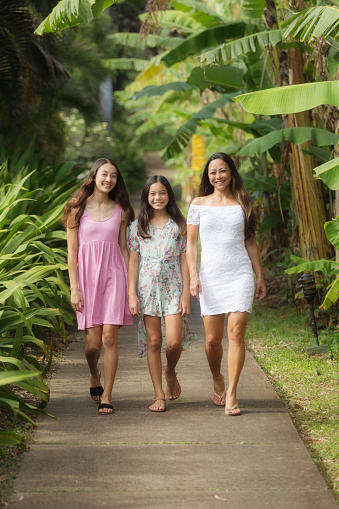 Family portrait of a Hawaiian family, with mother and two teen girls.
