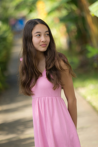 A young Hawaiian teen adolescent girl outdoor, looking away