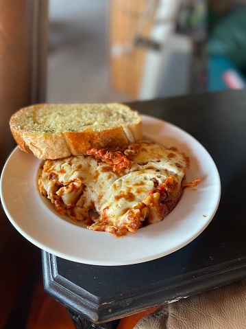 Lasagna with garlic toast on plate background