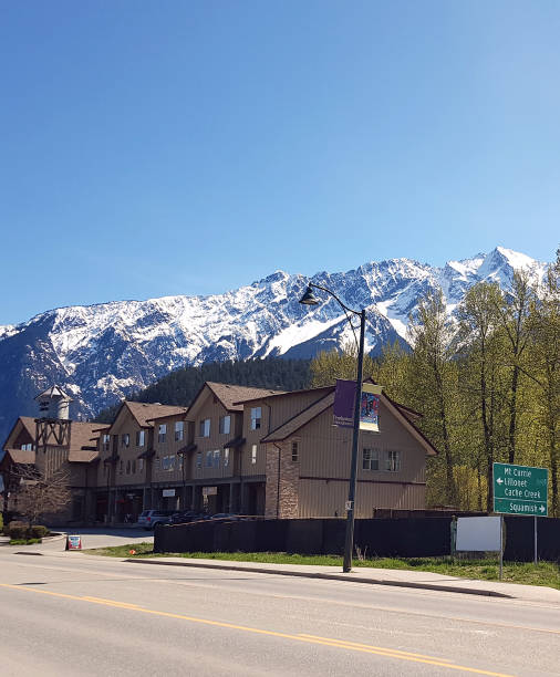 Small Town Pemberton BC Business With Snow Covered Mt Currie Main Highway into small town Pemberton BC. Business and residential buildings . Highway signage to Lillooet BC. Mt Currie in background.  Month of late April. Near Whistler BC. pemberton town stock pictures, royalty-free photos & images