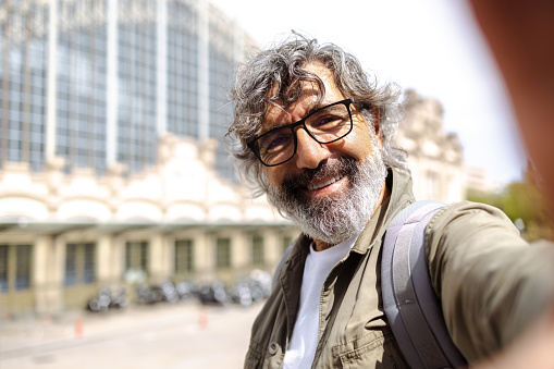 Senior man taking selfie on the street