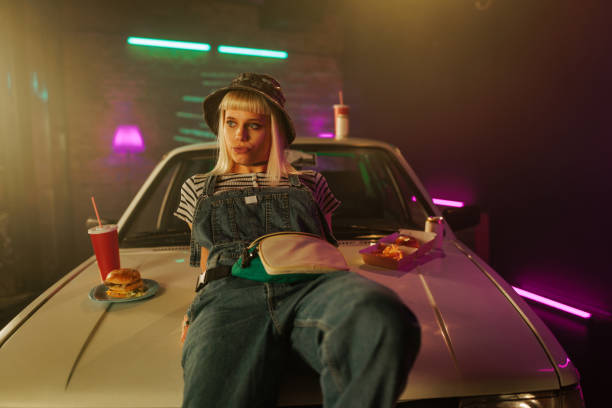 istock Woman relaxing on car hood. 1488224837