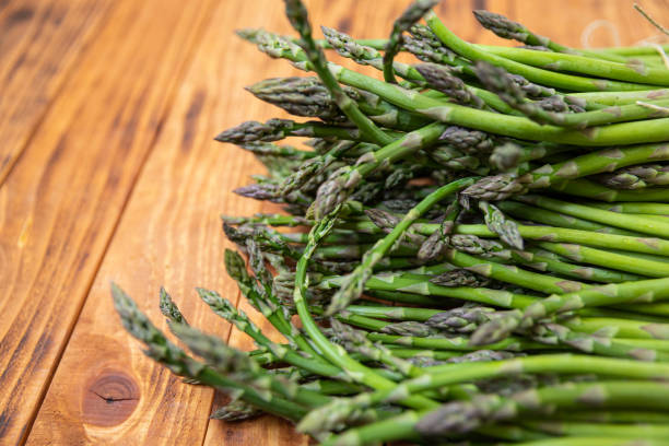 istock Bunch of raw asparagus spears, close up 1488226440