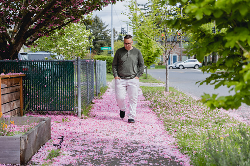 Portrait of a mid adult man outdoors in a residential neighborhood who is on the autism spectrum. He has ADHD as well as autism and enjoys life even with some of the challenges presented with his diagnosis.