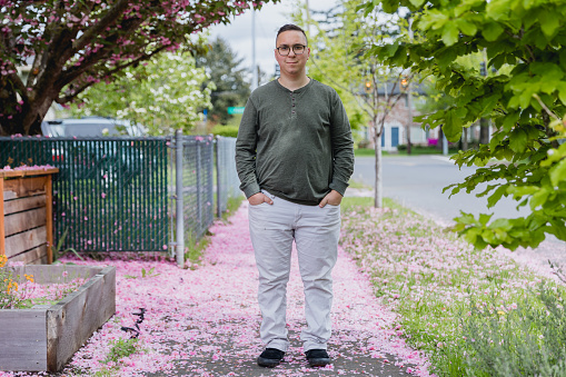 Portrait of a mid adult man outdoors in a residential neighborhood who is on the autism spectrum. He has ADHD as well as autism and enjoys life even with some of the challenges presented with his diagnosis.
