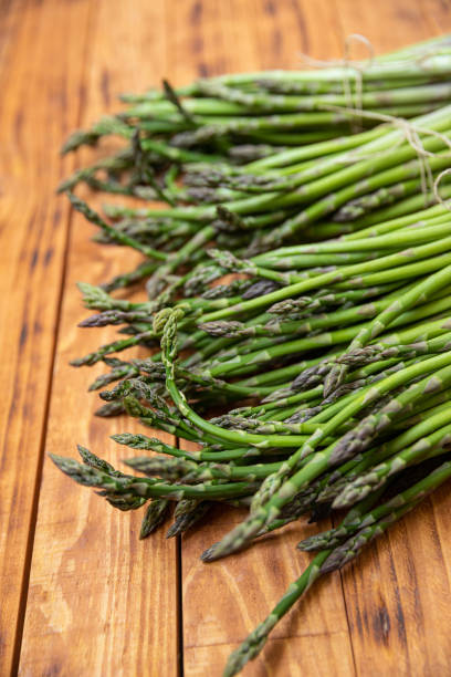istock Bunch of raw asparagus spears, close up 1488226755