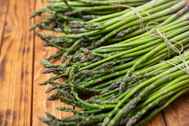 istock Bunch of raw asparagus spears, close up 1488227759
