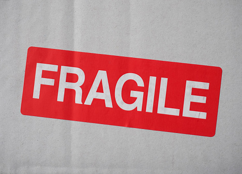 fragile warning sign label tag on a cardboard box