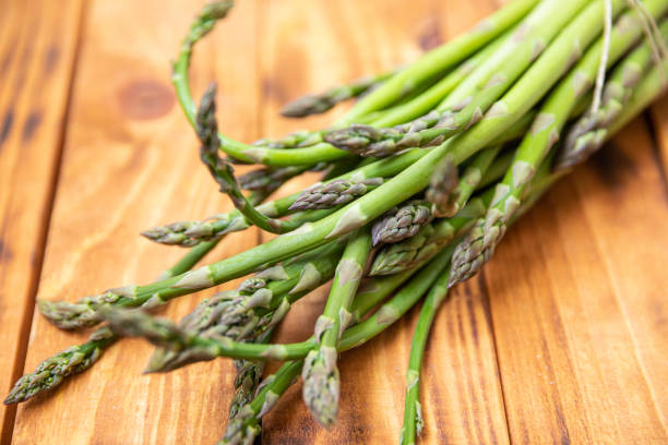 istock Bunch of raw asparagus spears, close up 1488228295
