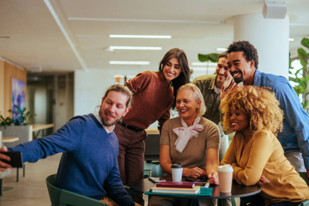 istock Coworkers taking selfie on break in office. 1488229887